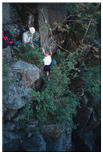 Andrew belaying Annette up a vertical climb in Trap Dike